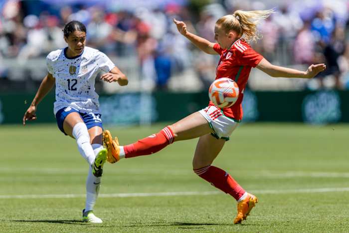 Jul 9, 2023; San Jose, California, USA; United States of America defender Alana Cook (12) passes past Wales midfielder Ceri Holland (7) during the first half at PayPal Park. Mandatory Credit: John Hefti-USA TODAY Sports